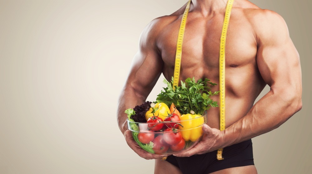 man-with-muscles-standing-with-food