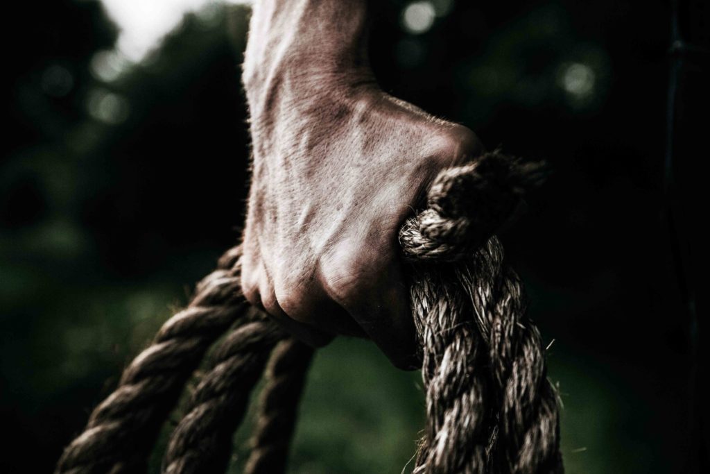 man-holding-brown-rope-