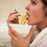 A girl eating instant noodles